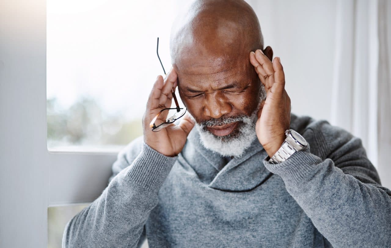 Man suffering from a migraine.