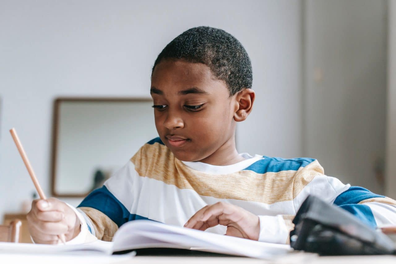 Young boy doing schoolwork.