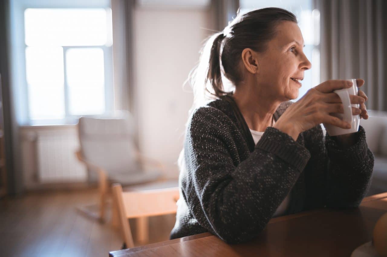 Older woman enjoying coffee in the morning.