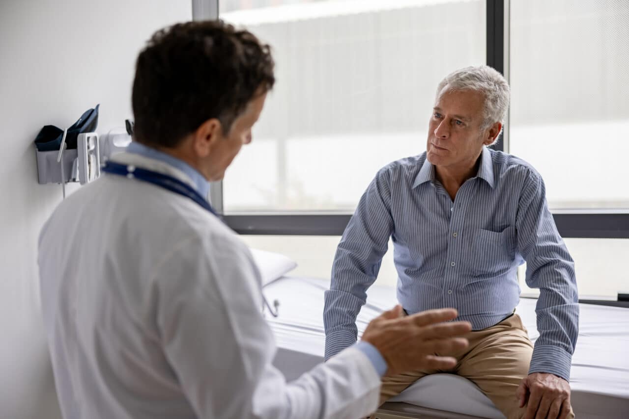 Doctor talking to patient in an exam room setting