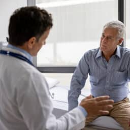 Doctor talking to patient in an exam room setting