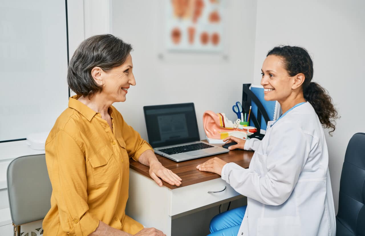 Senior woman having a consultation with her audiologist about hearing loss.