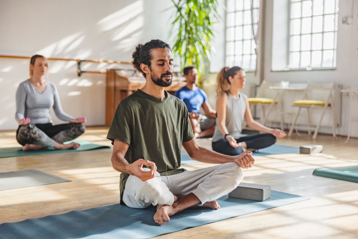 Calm man meditating in a yoga class.