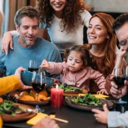 Happy extended family celebrating Thanksgiving at dining table