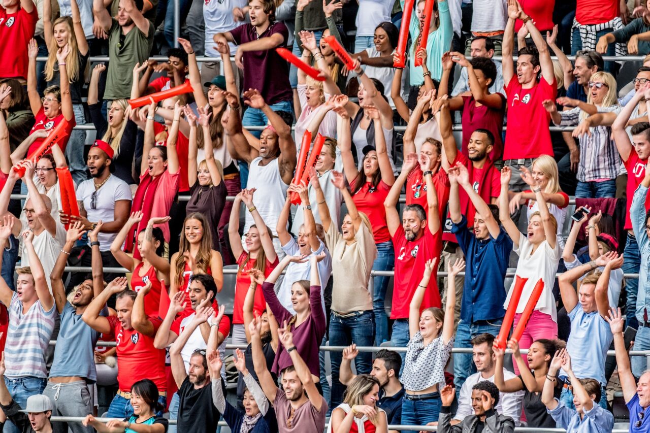 Loud crowd cheering on their sports team.